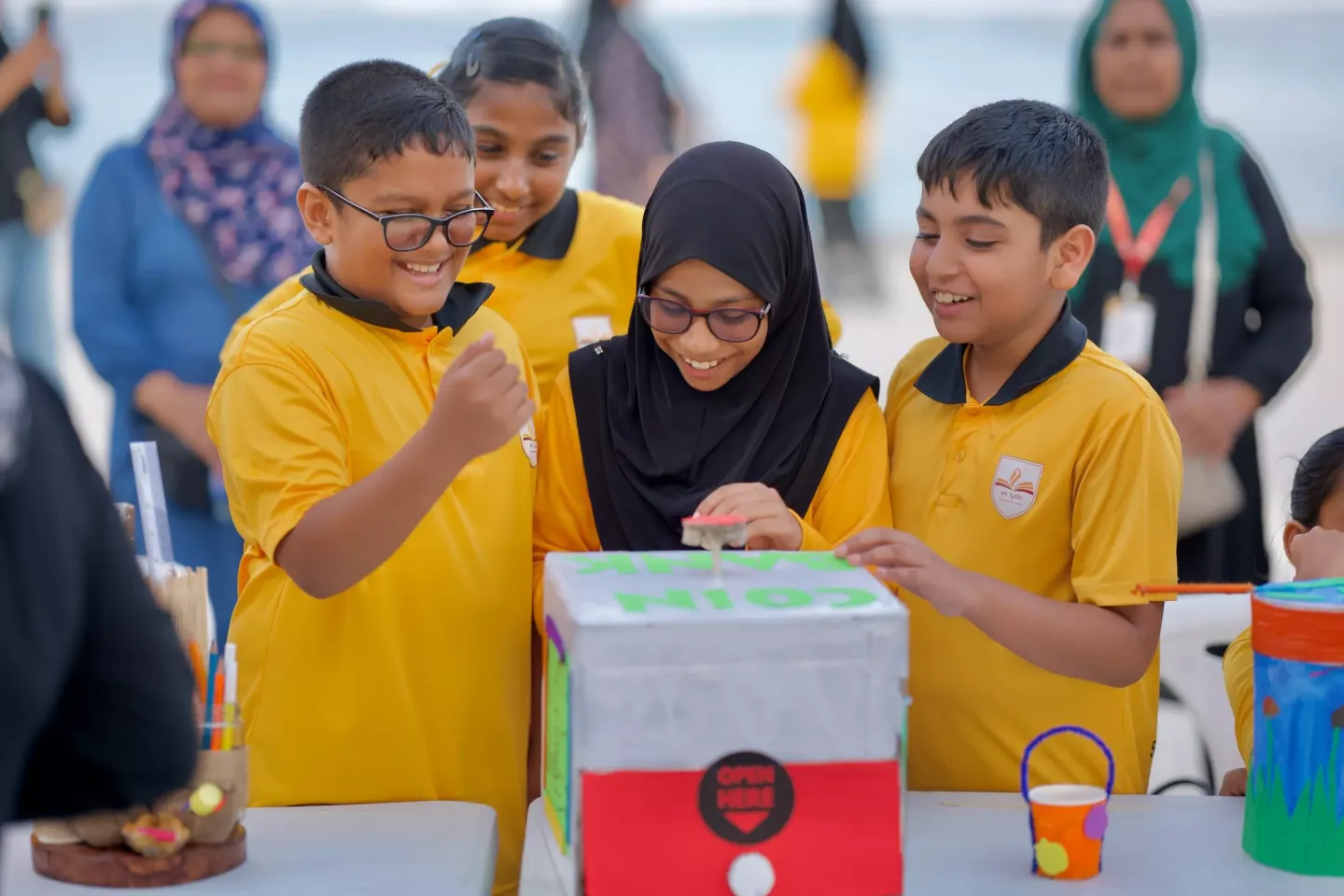 A group of school children around an arts and craft model