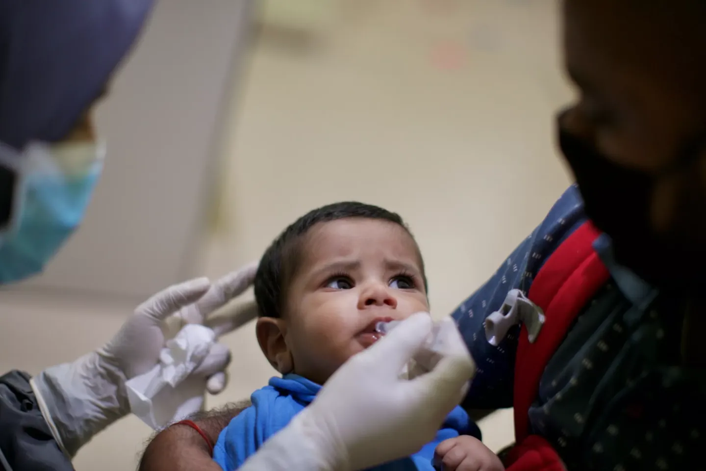 A baby boy getting an oral vaccine