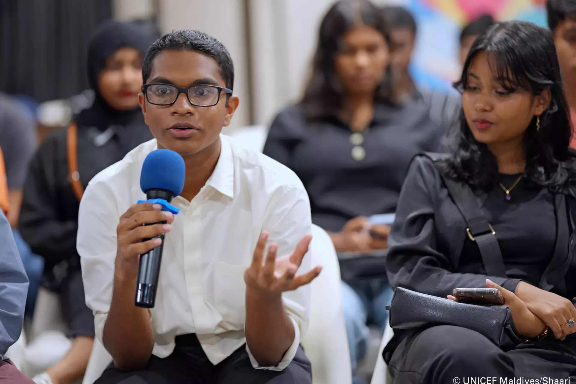 A young person speaking at a session