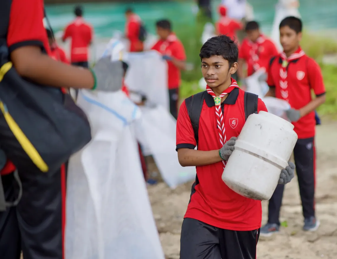 A Scout participating in a clean up
