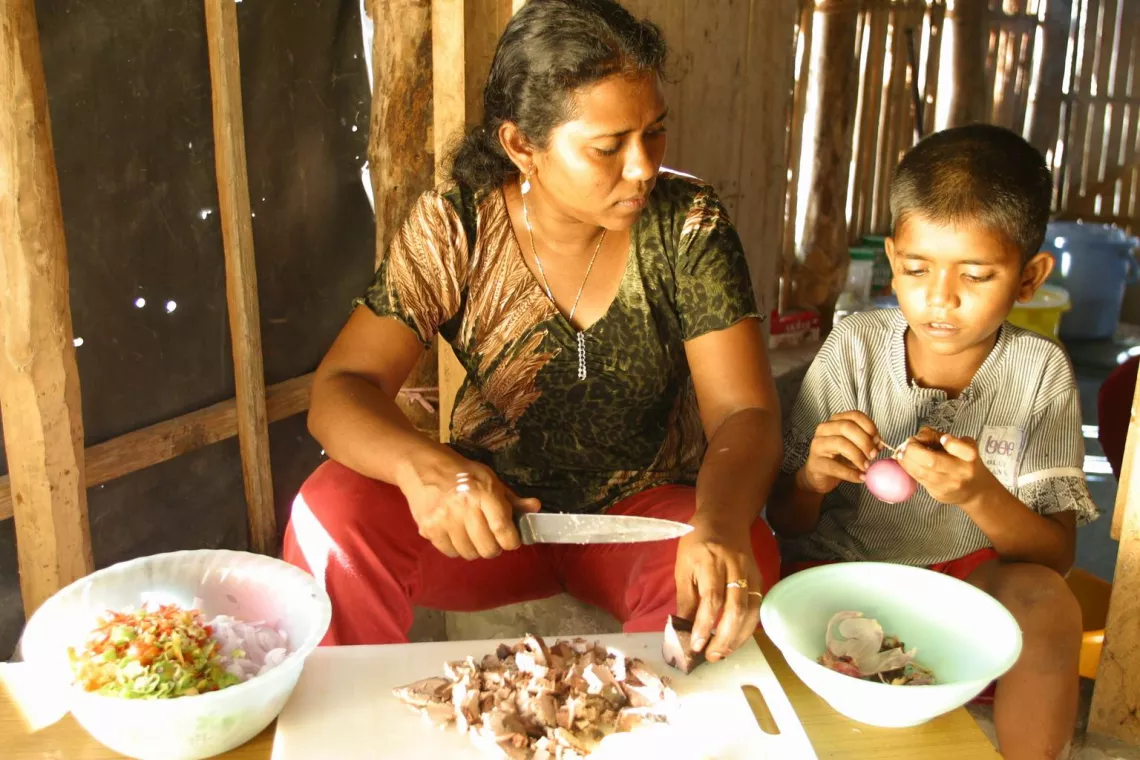 A mother and child cook.