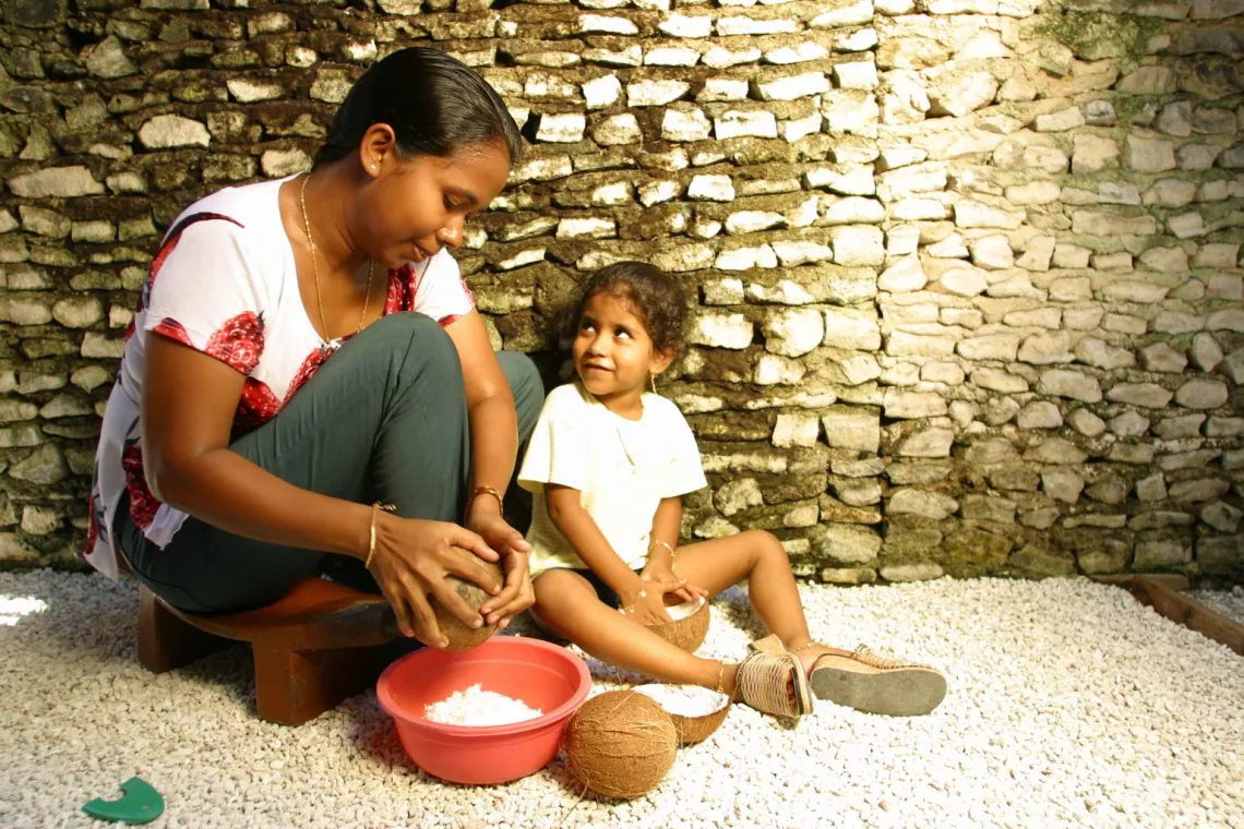 A child and mother make lunch in Maldives.