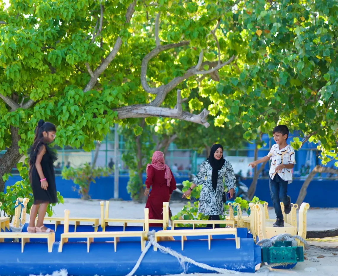Adolescents playing on the playground of an island