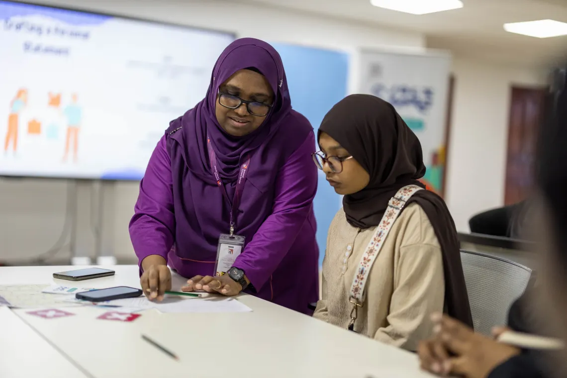 A young person receiving guidance from a teacher