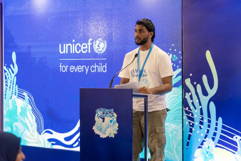 Participant at Youth Track to COP31 presenting at the podium