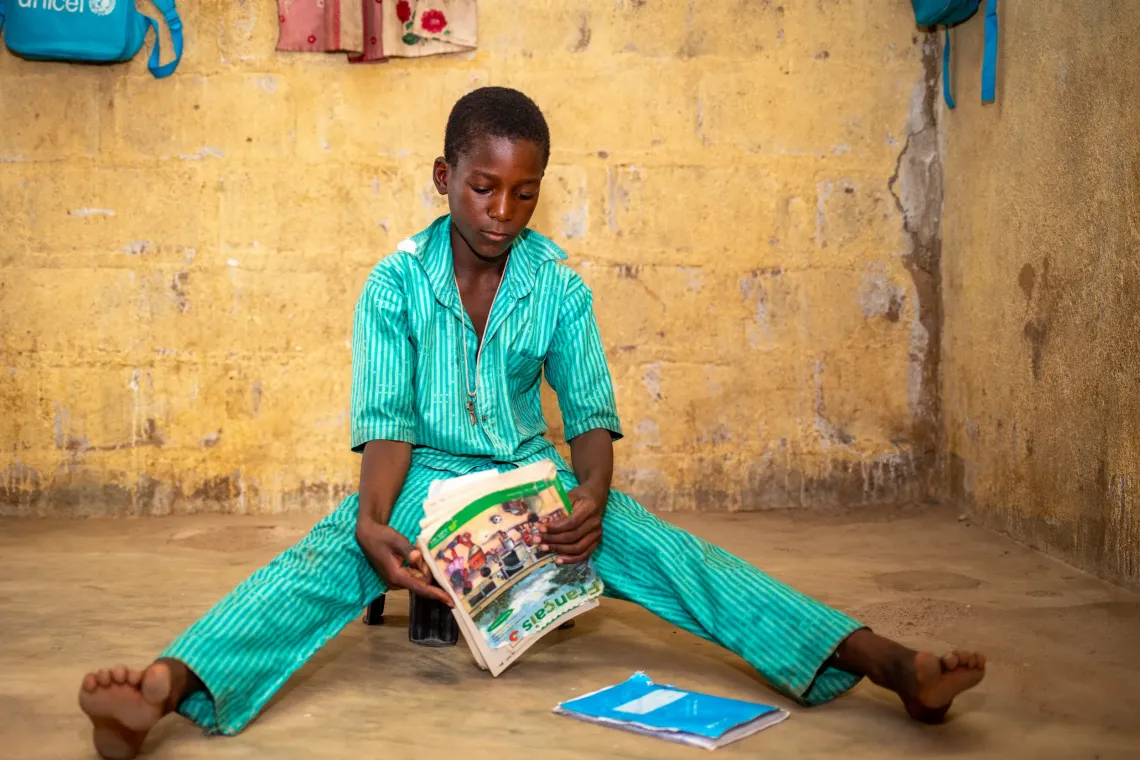 Mahamadou, 10, reviewing his lessons learned in class.