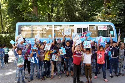 Kids in front of a bus