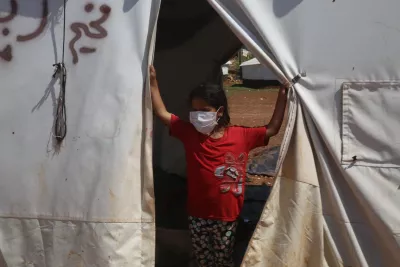 a girl with a mask looking out of a tent