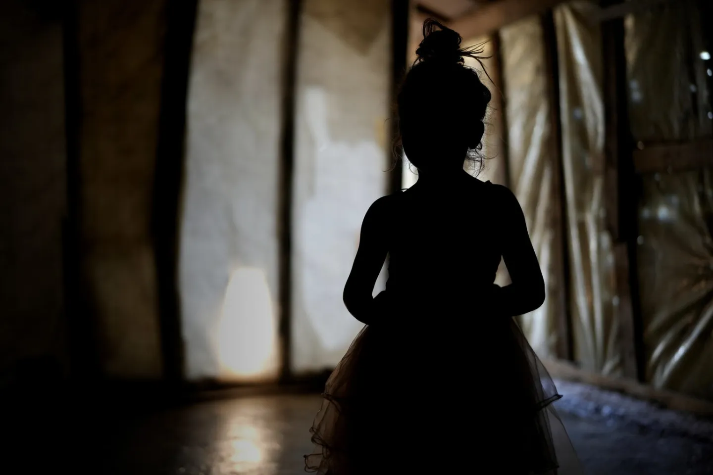 a silhouette of a girl in a tent
