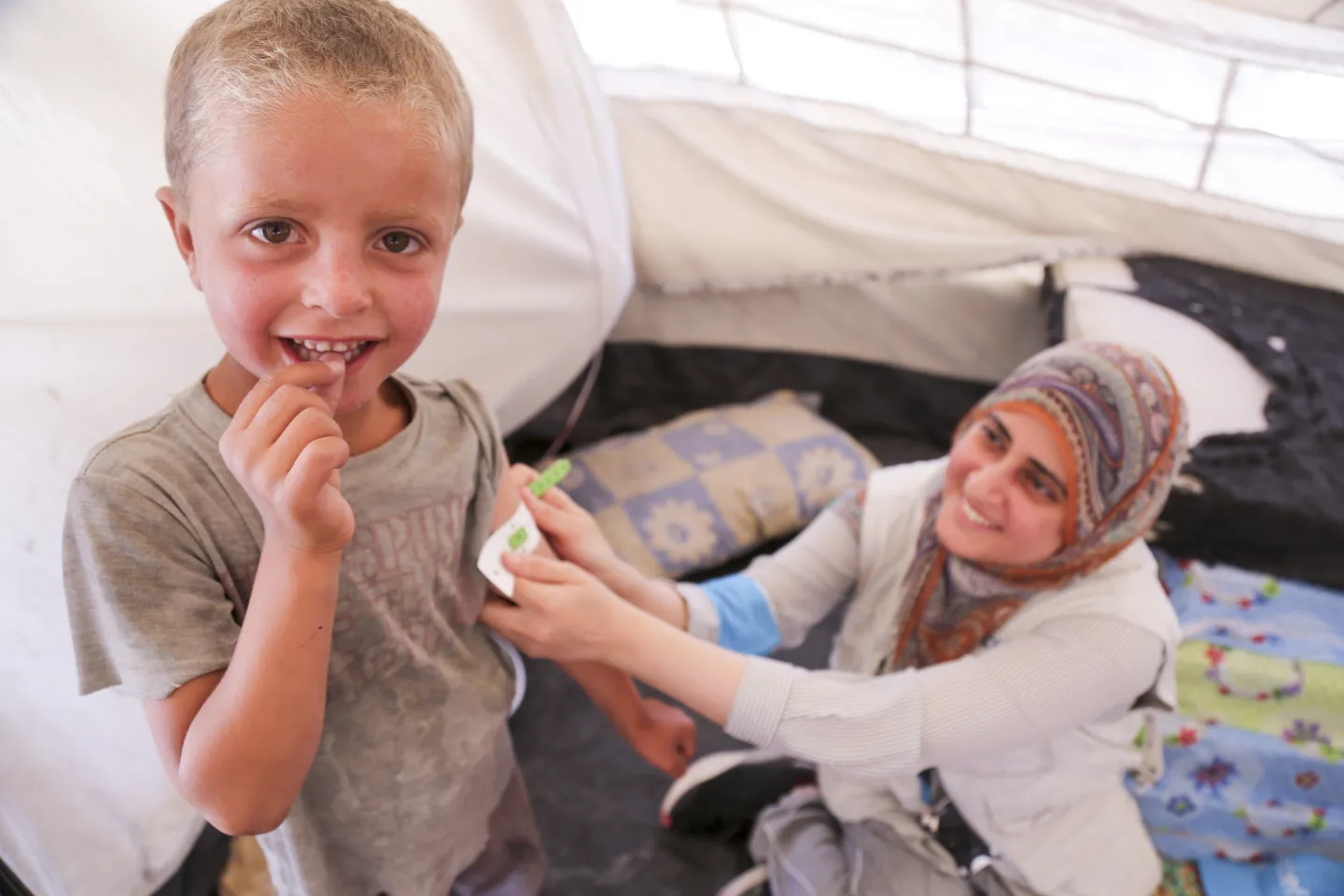health worker measuring arm circumference of a child