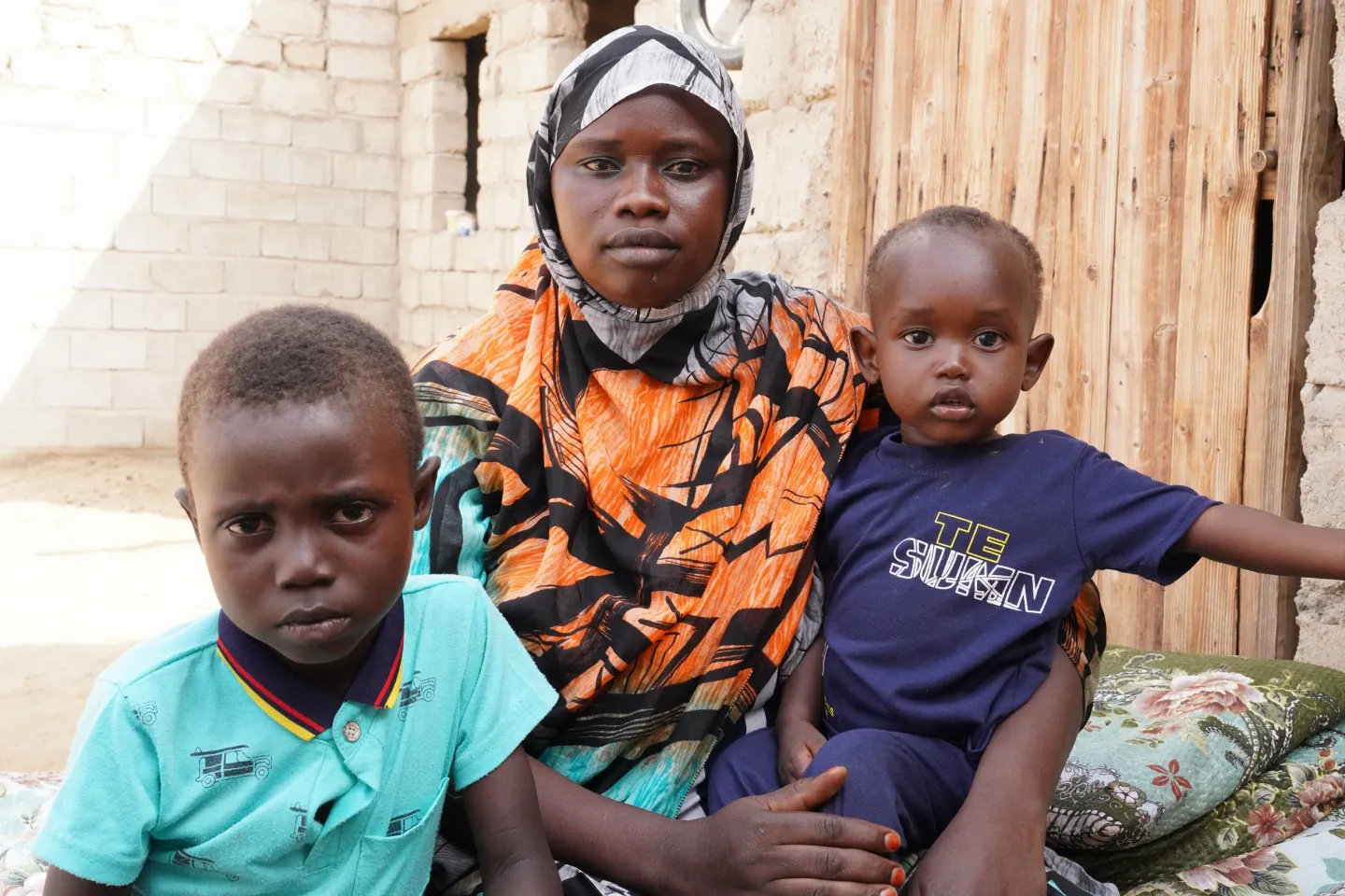 Rugayia Mustafa Abdallah Mohammed, a 26-year-old mother and her two sons at her household in Port Sudan. Her youngest son, Amar Motassim, is 15 months old. She has received two tranches of cash from the Mother and Child Cash Transfer Plus (MCCT+) programme and spent the money on nutritious food for the family. Before she registered on the programme, she did not know the importance of antenatal care and family planning. Since she registered in the programme, Rugaiya has been guided on the use of contraceptiv
