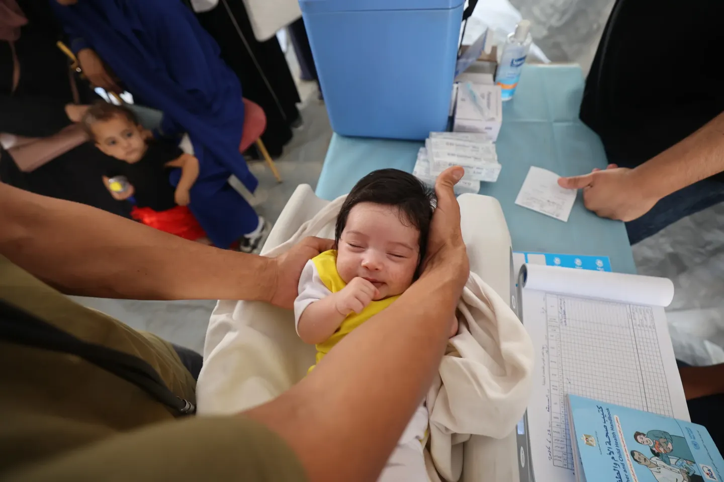 Infant Lia will receive her recommended vaccinations at the Gaza City mobile clinic. Vaccines are an important protection, especially in Gaza, where disease spreads quickly amidst crowding and lack of clean water. 