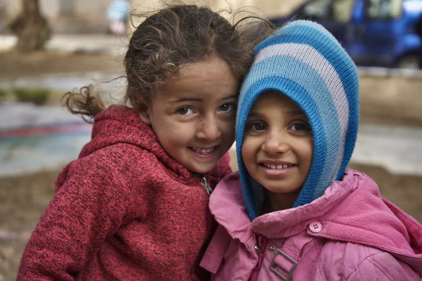 Children smiles standing outside their house during a graffiti activity organized by UNICEF supported NGO in Naja Gmouri neighbourhood in the city of Kasserine. Tunisia.