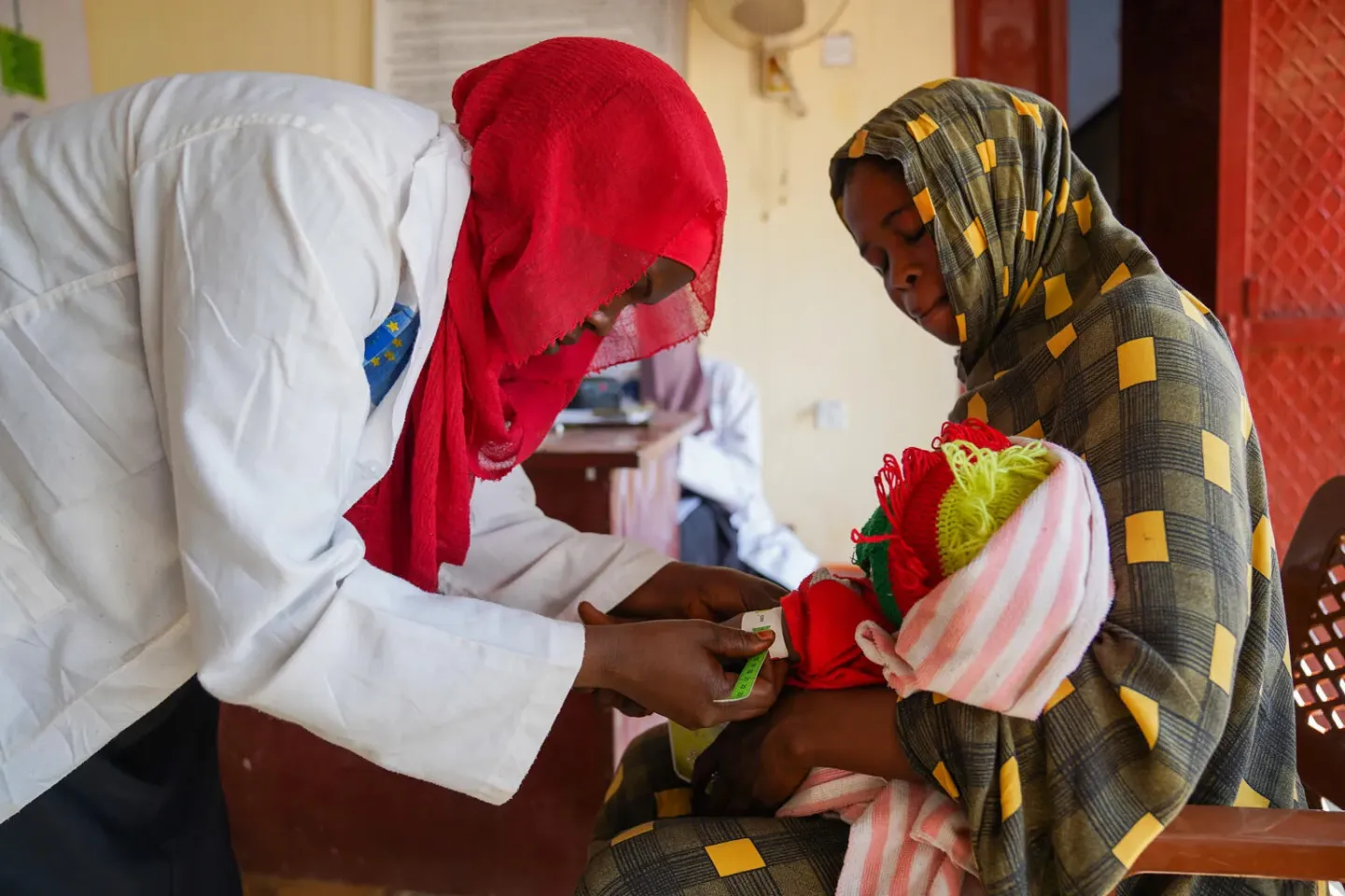 Sudan. A nutritionist screens children at a health centre in Central Darfur.