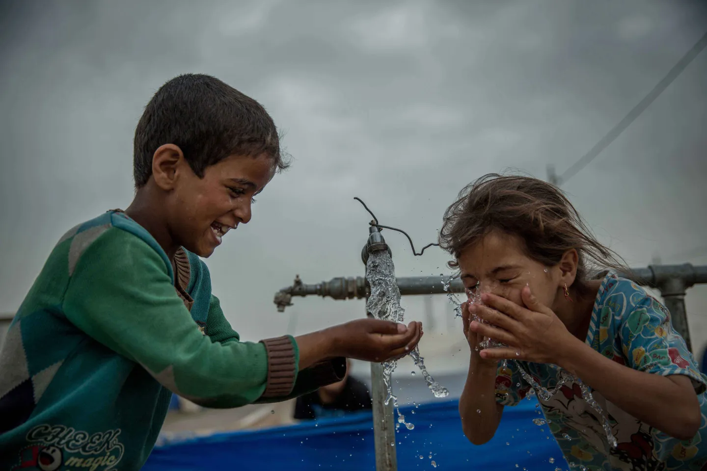 Kids washing hands outdoors