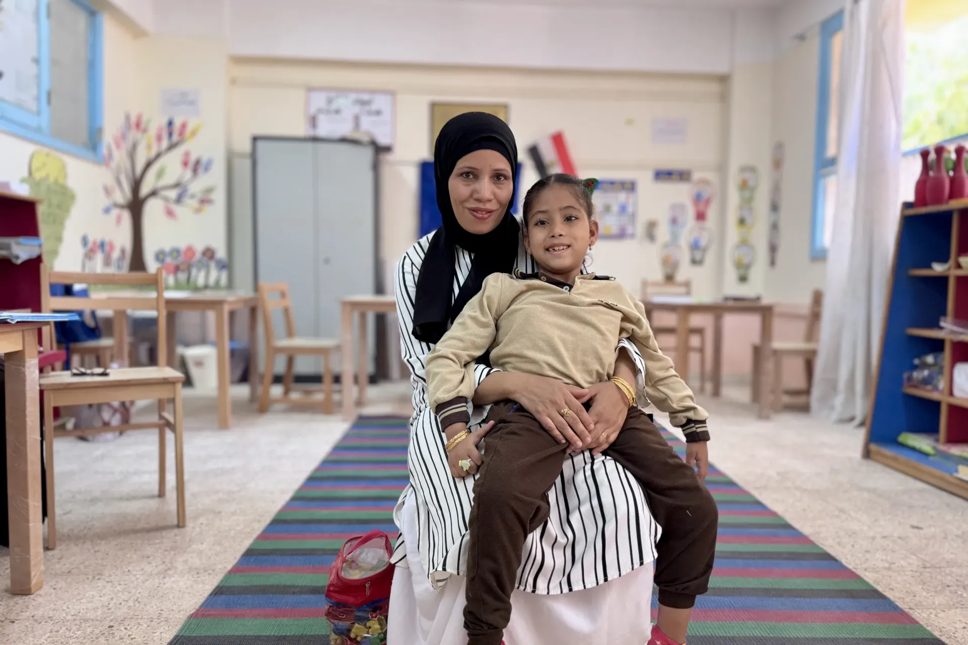 Malak and her mother in a classroom
