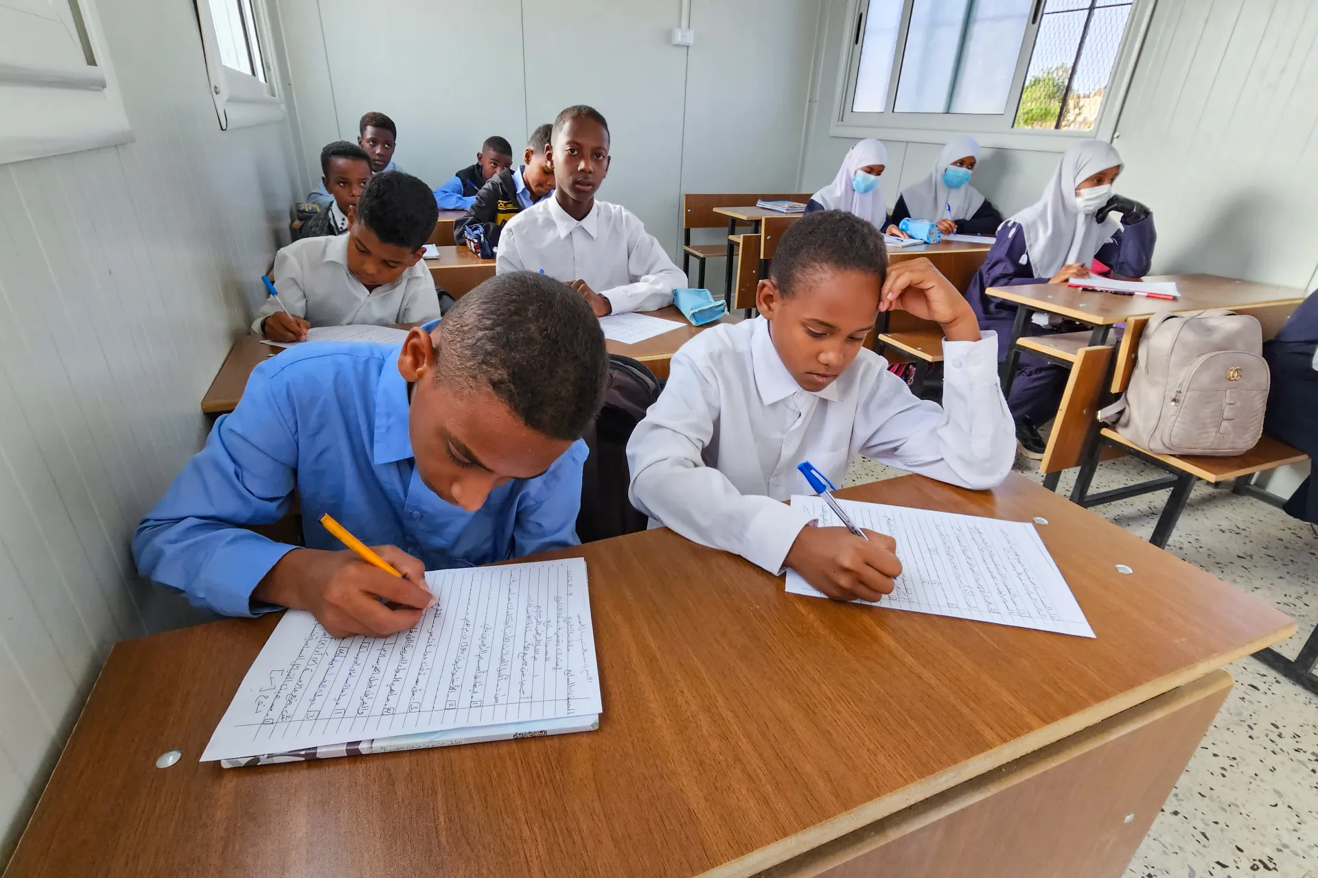Students engage in their lessons inside the prefabricated classroom at Taqrouteen School. Photo: &copy;UNICEF/Wadi Otbah/2023/Abdullah Hussein