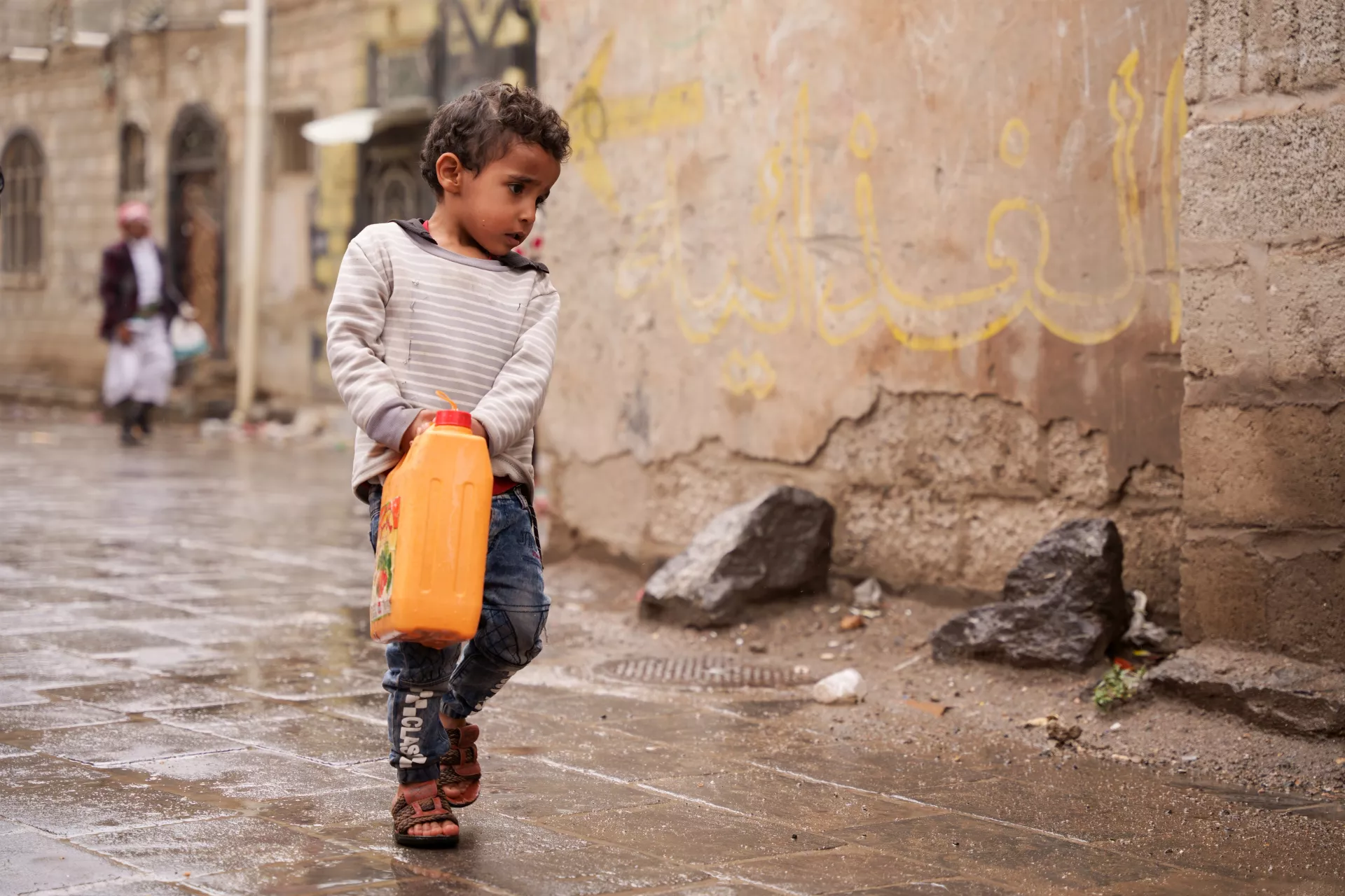 On 13 March 2023, Mohammed, Nabil's son, helps his father to fetch water from a nearby charity tank in Dhamar Governorate, Yemen.