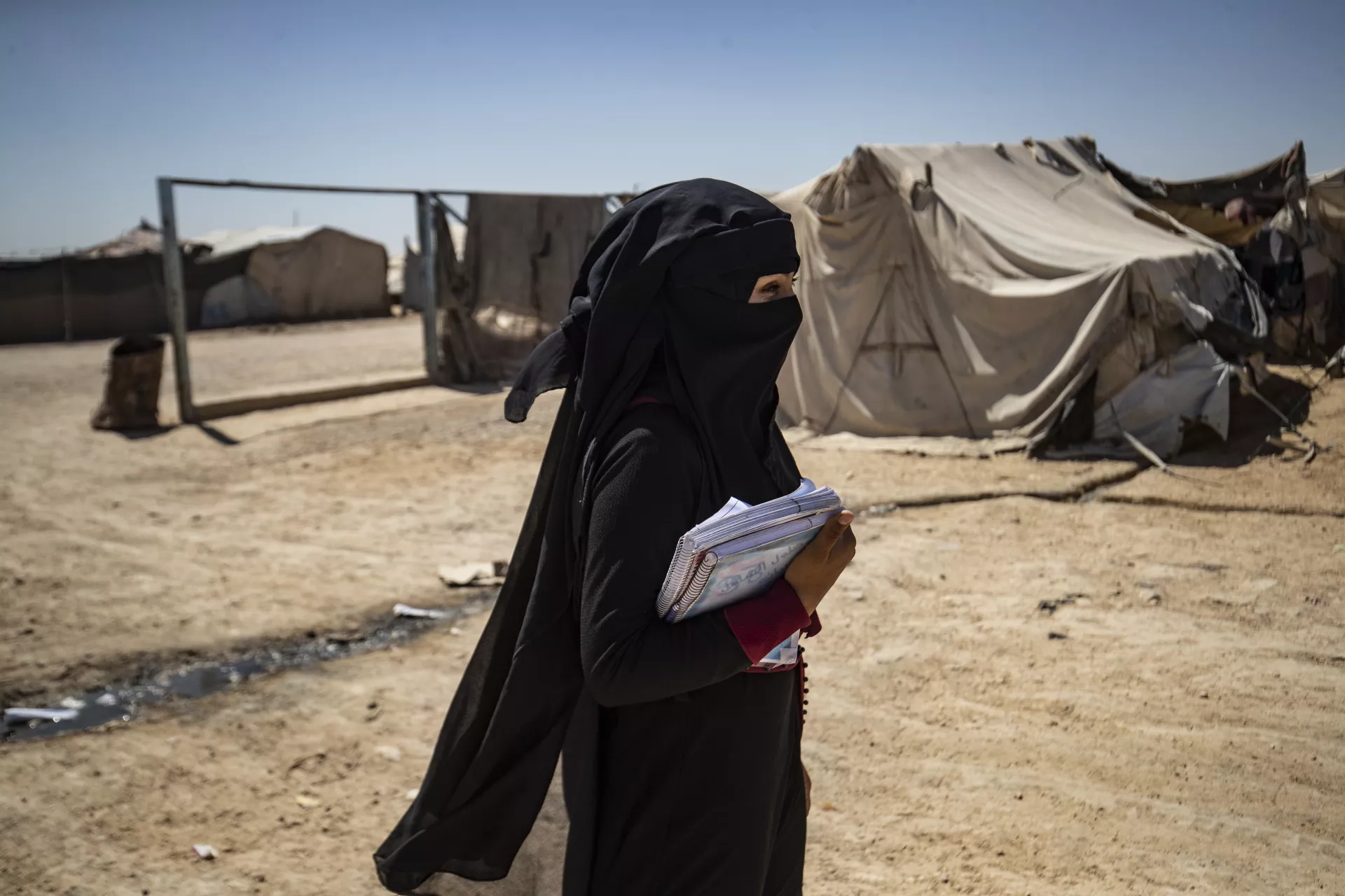 Rima, 19, in Areesheh camp, northeast Syria, going to the exam transportation gathering point, to sit for her Grade 12 national exams in Al-Haskah city.