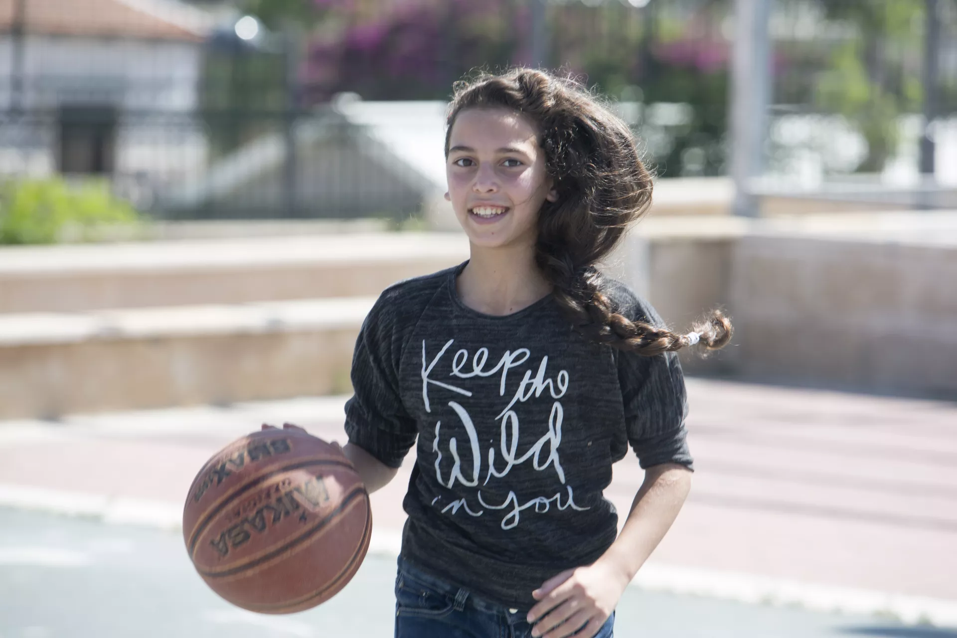A girl playing Basketball
