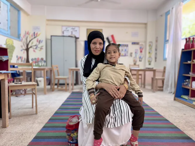 Malak and her mother in a classroom