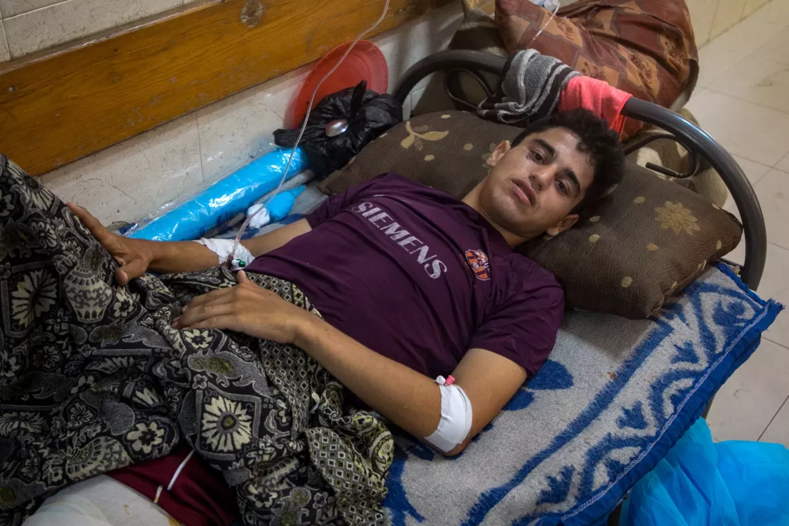 Gaza. Bilal lays on a bed in a hospital.
