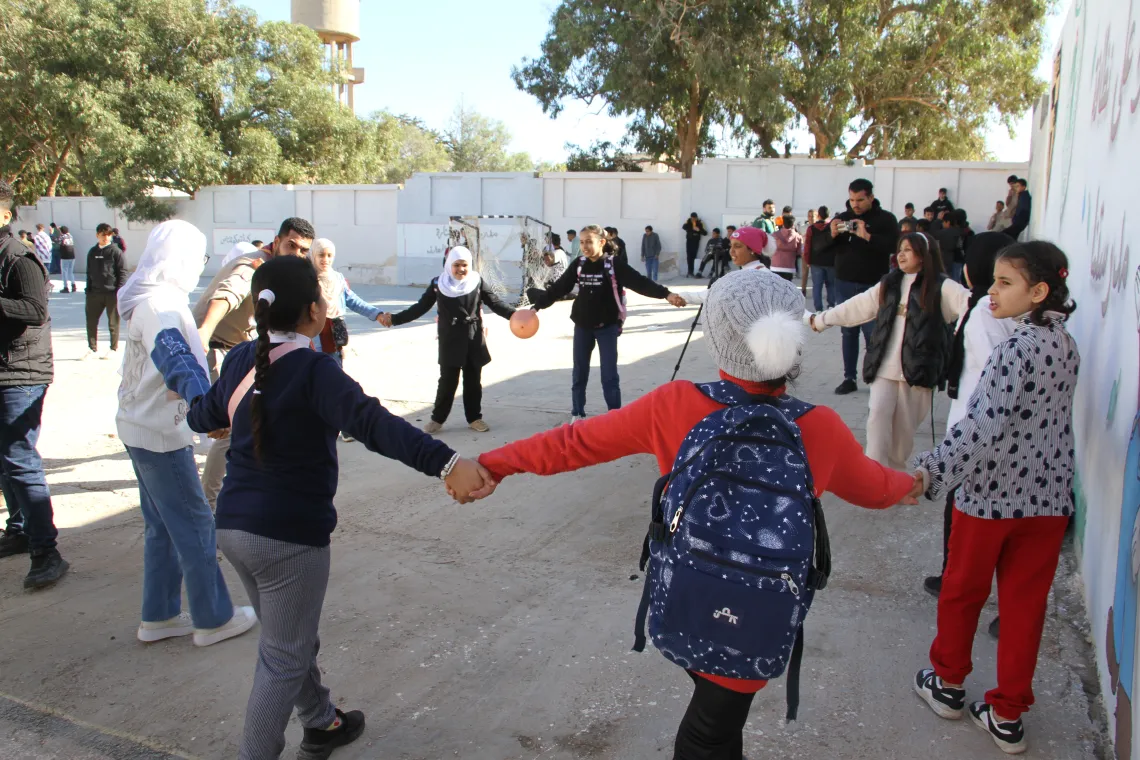 Islam, scouts lead a circle of children through a psychosocial support session in the wake of the storm."