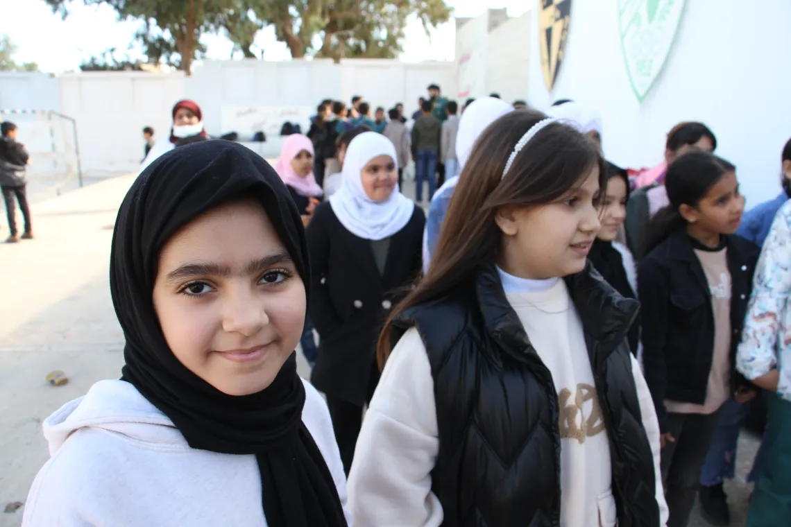 Nouria, with a hopeful gaze, stands among with peers (Basant on her left) during a psychosocial session, a testament to the spirit of the young in rebuilding their lives after the storm. 