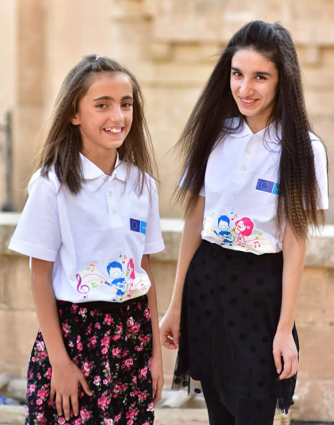 Two girls smiling to the camera
