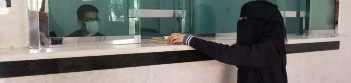 a woman receiving cash assistance