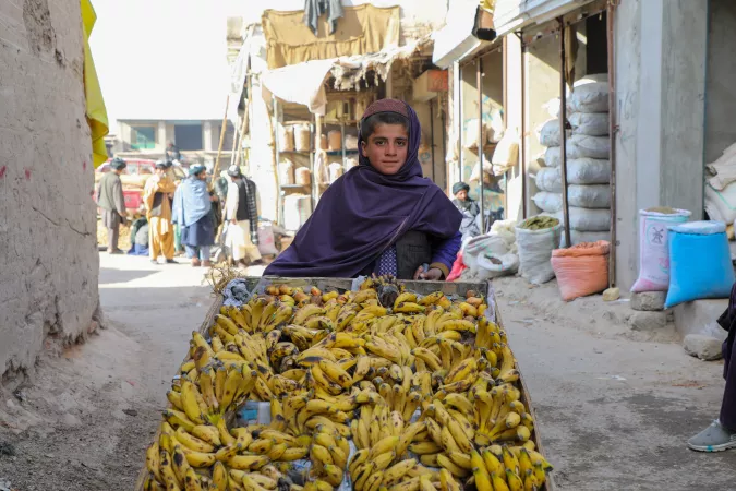 Rafiqullah, 12, sells bananas in Tarinkot, capital of Uruzgan Province in Afghanistan. Due to poverty and lack of access, he cannot attend school.