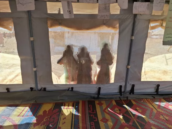 On 3 December 2024, children peer through a UNICEF tent at a child-friendly space (CFS) in Kassala state, Sudan. 