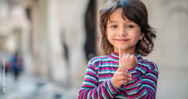 A girl shows her marked finger after receiving the Polio vaccine, Aleppo, Syria