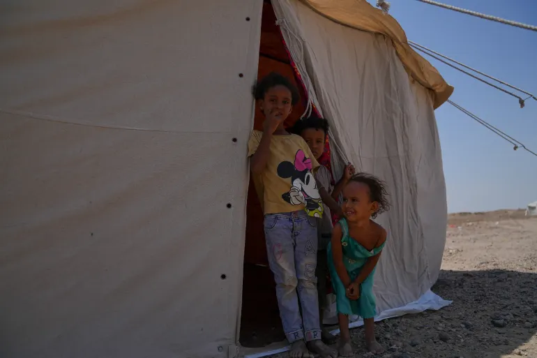 children at the entrance of their tent