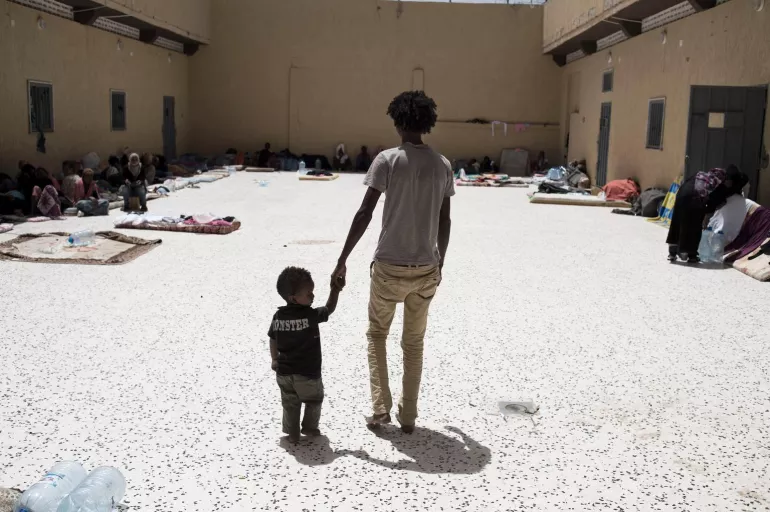 A father and a child in a detention facility