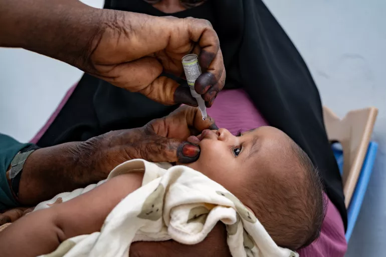 On 10 April, Intesar, a vaccinator, vaccinates children at Al Thorwa health centre in Kassala state.