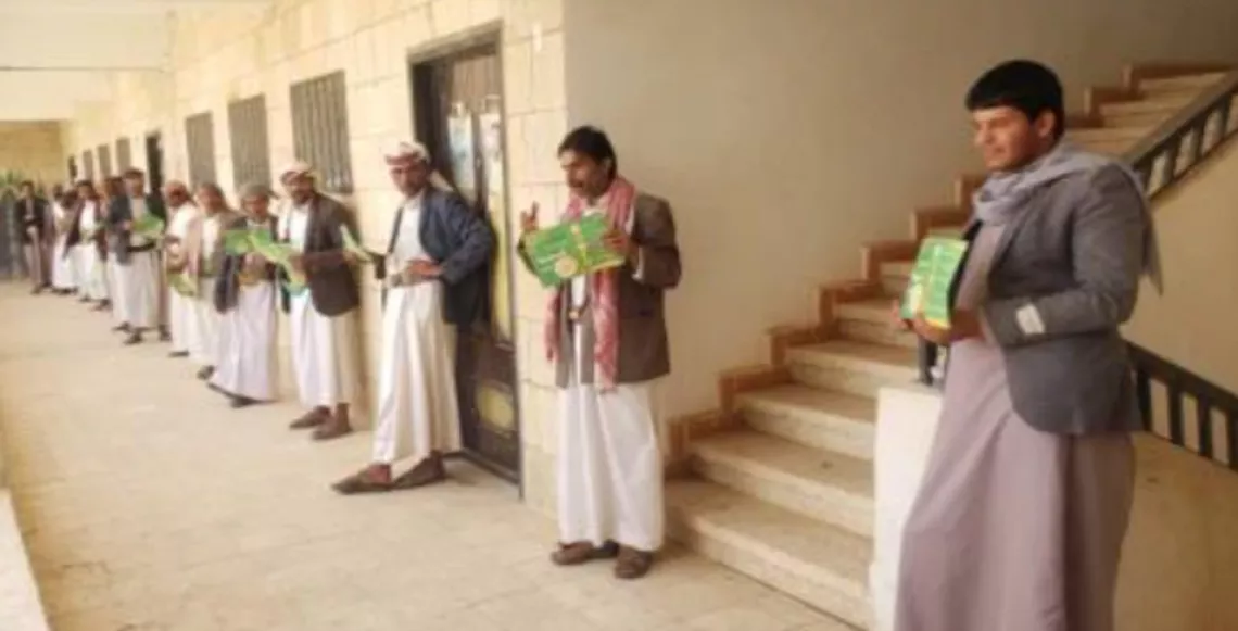 men standing in a line holding informative flyers