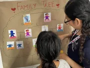 A student is creating her family tree with the support of the English teacher.