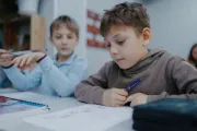 Refugee children learning romanian