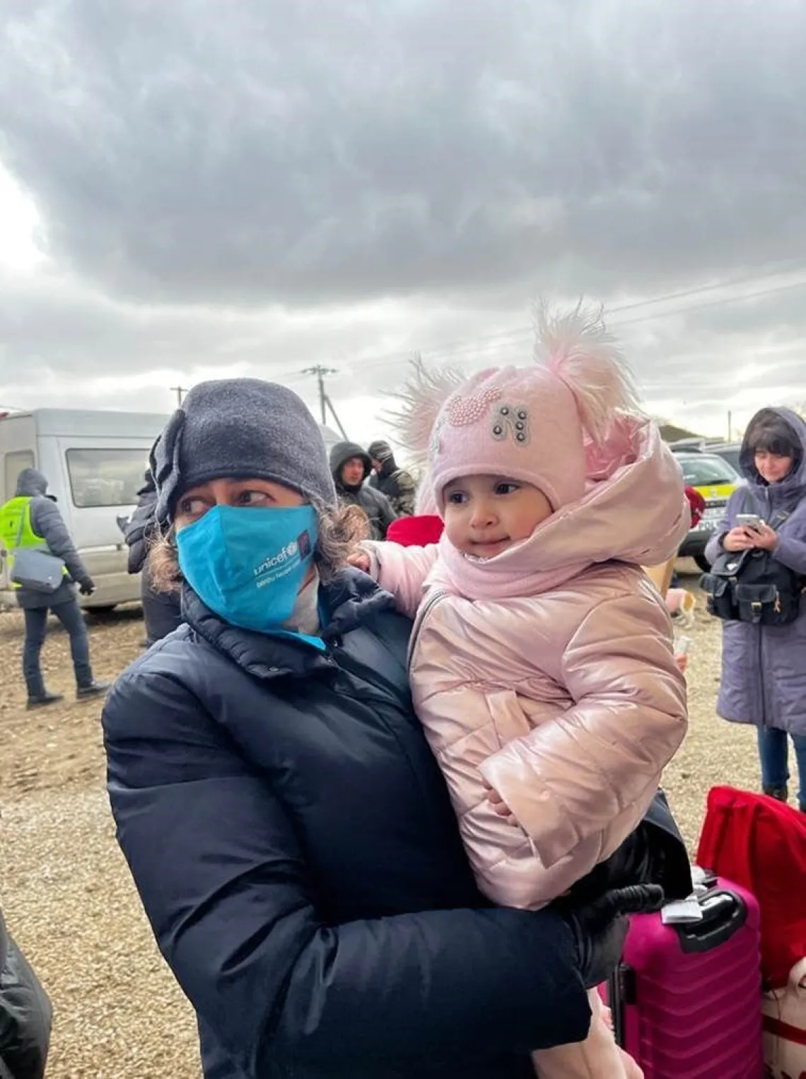 Afshan Kahn, Gheorghe Trofin and Maha Damaj meet a mother and her children at the border crossing in Palanca.