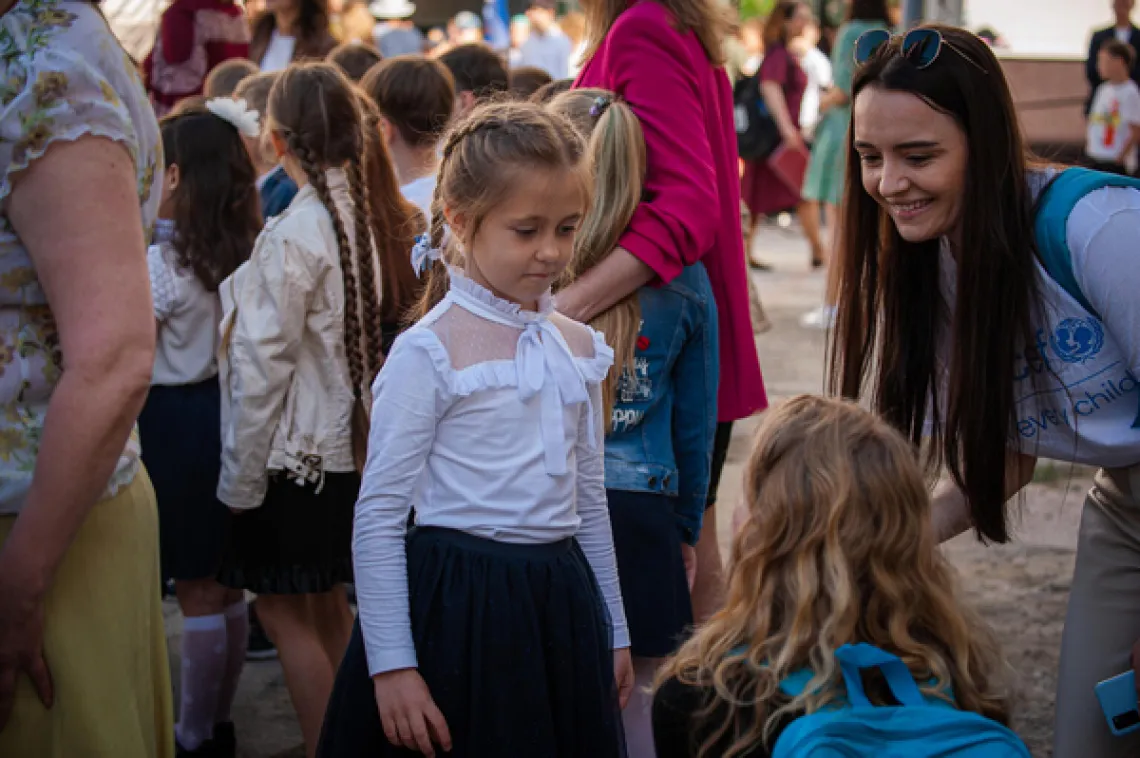Seven-year-old Rita from Odessa introduces herself to Adriana and Shelley from UNICEF.