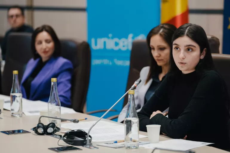  The image features three individuals: a young lady and two women, actively participating in the event.