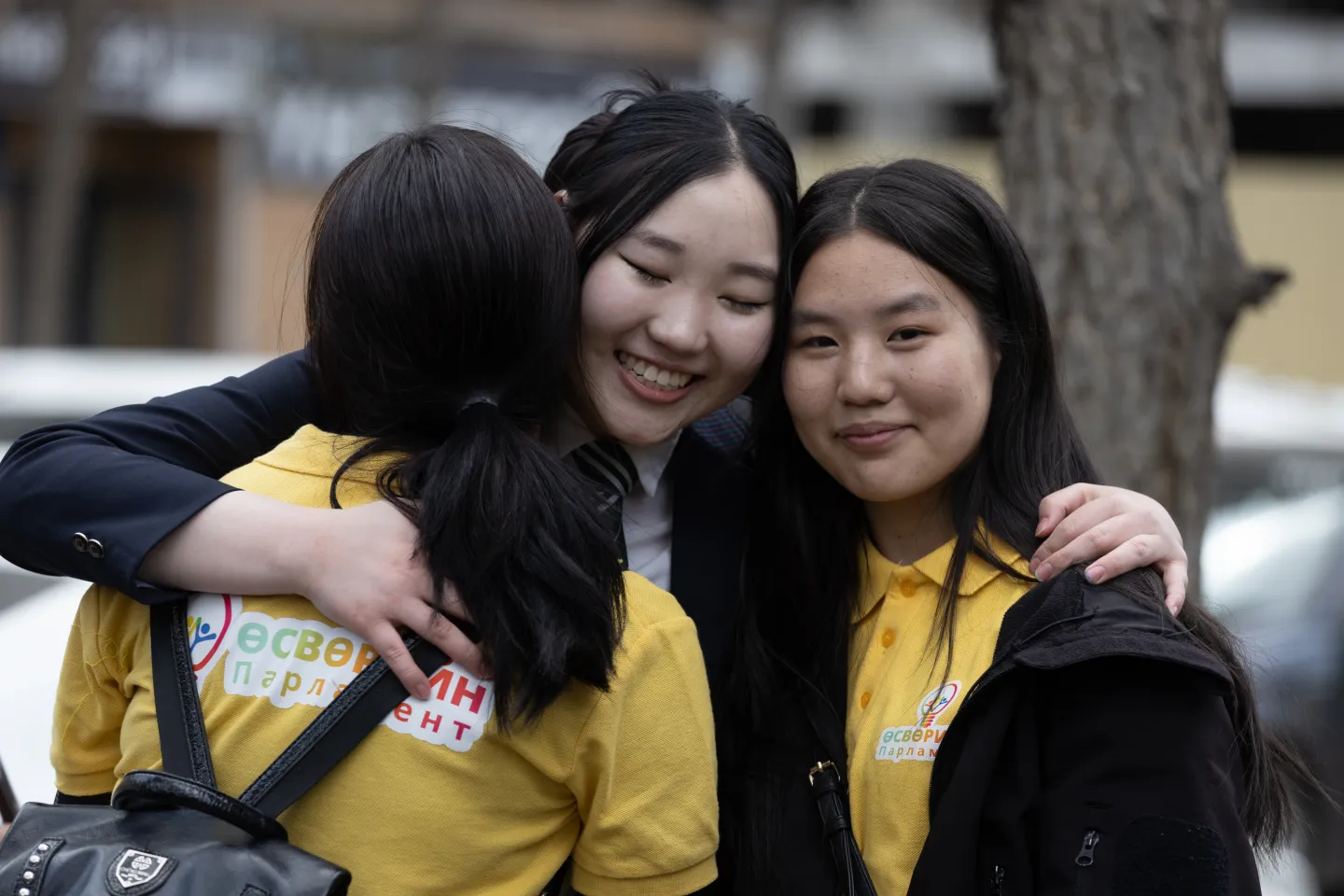 Teen parliament members hugging each other