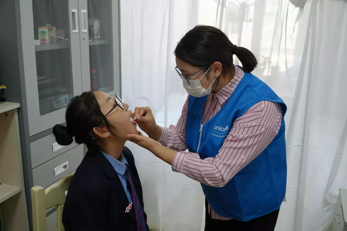 Nandin Erdene getting checked by a healthcare worker at Bulgan province&rsquo;s Health center.