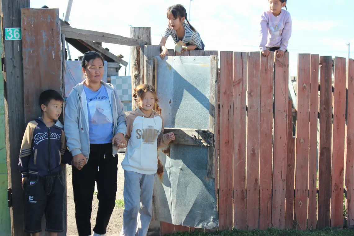 B.Otgon-Erdene, a 34-year-old mother of five children outside her home.  