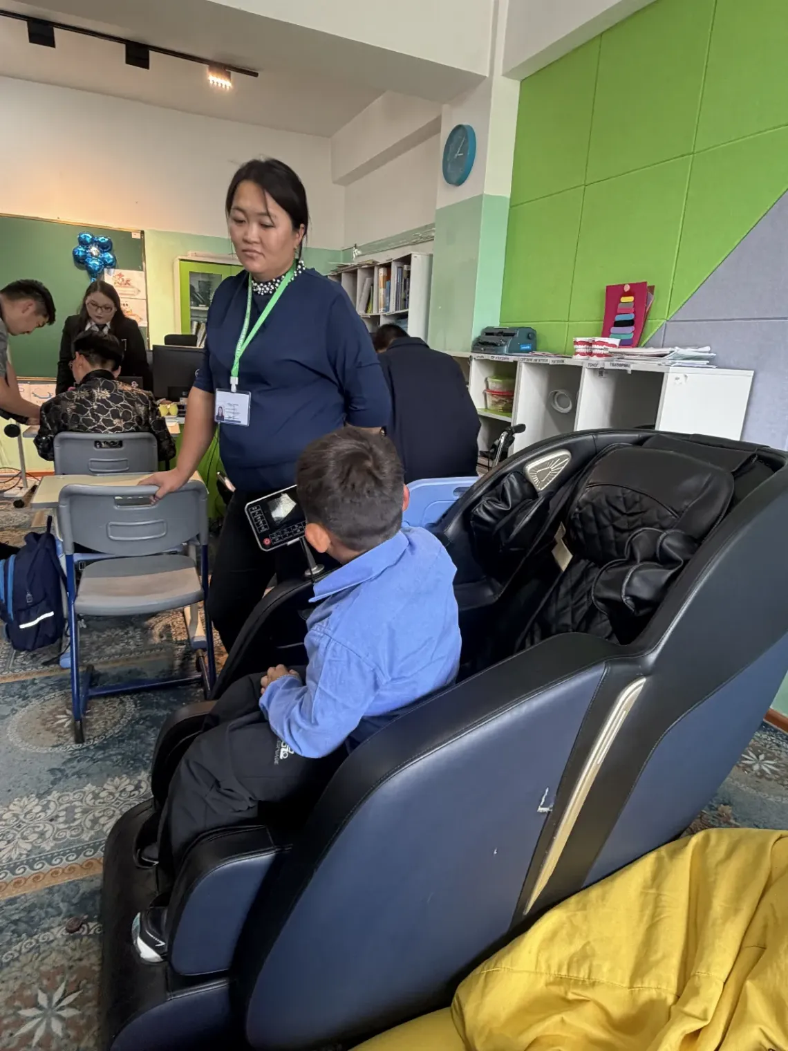 A child is using massage chair at the center