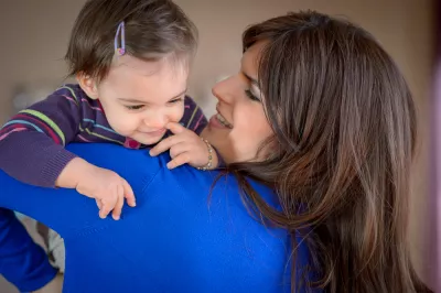 A mum with a daughter in her arms