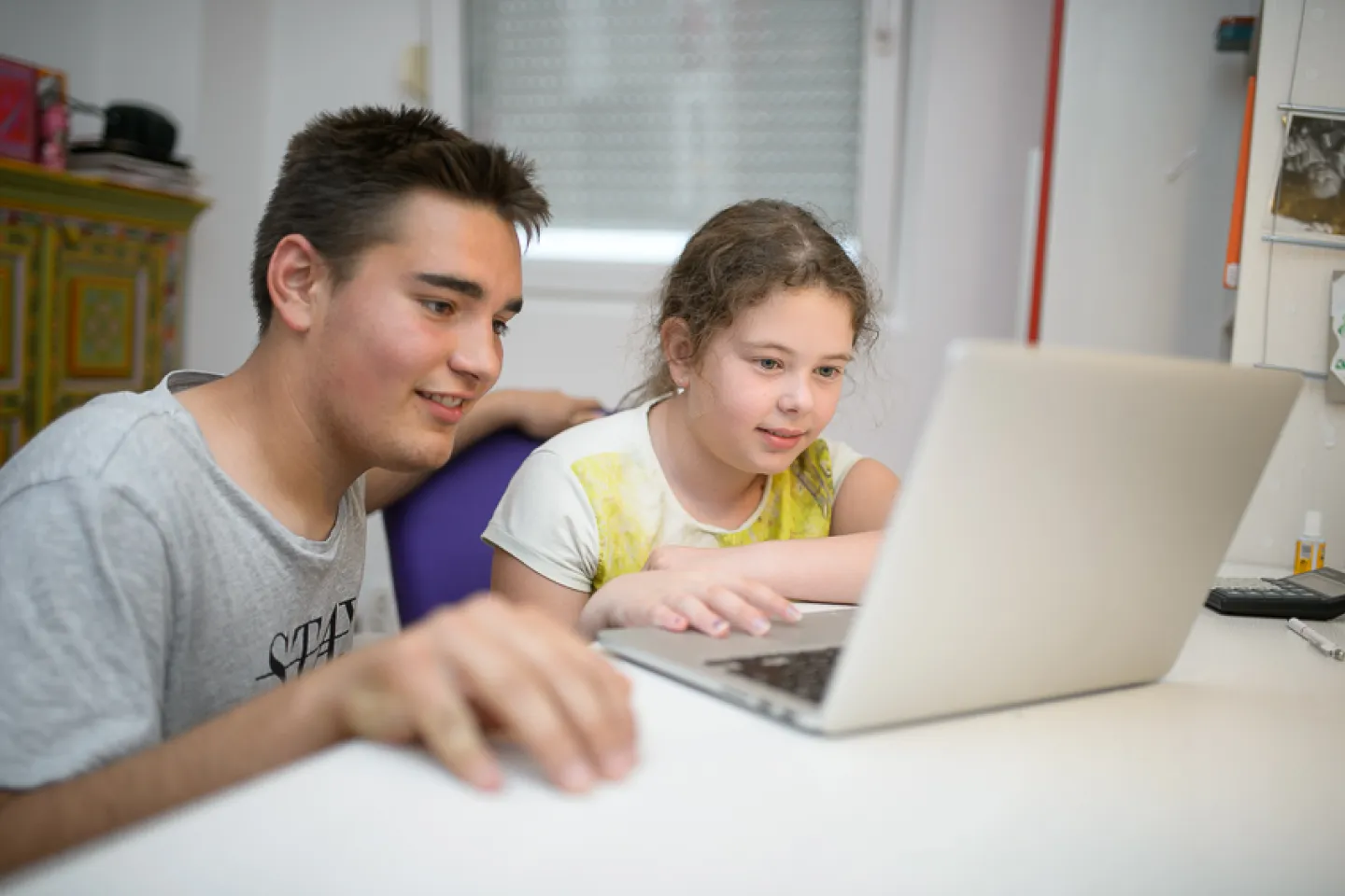 A boy and a girl with a lap-top