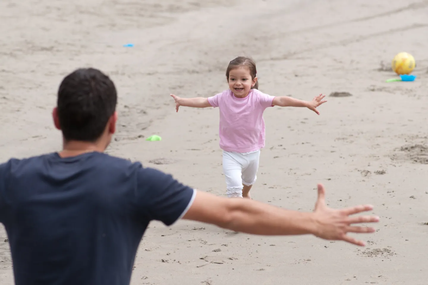 a girl running to her father