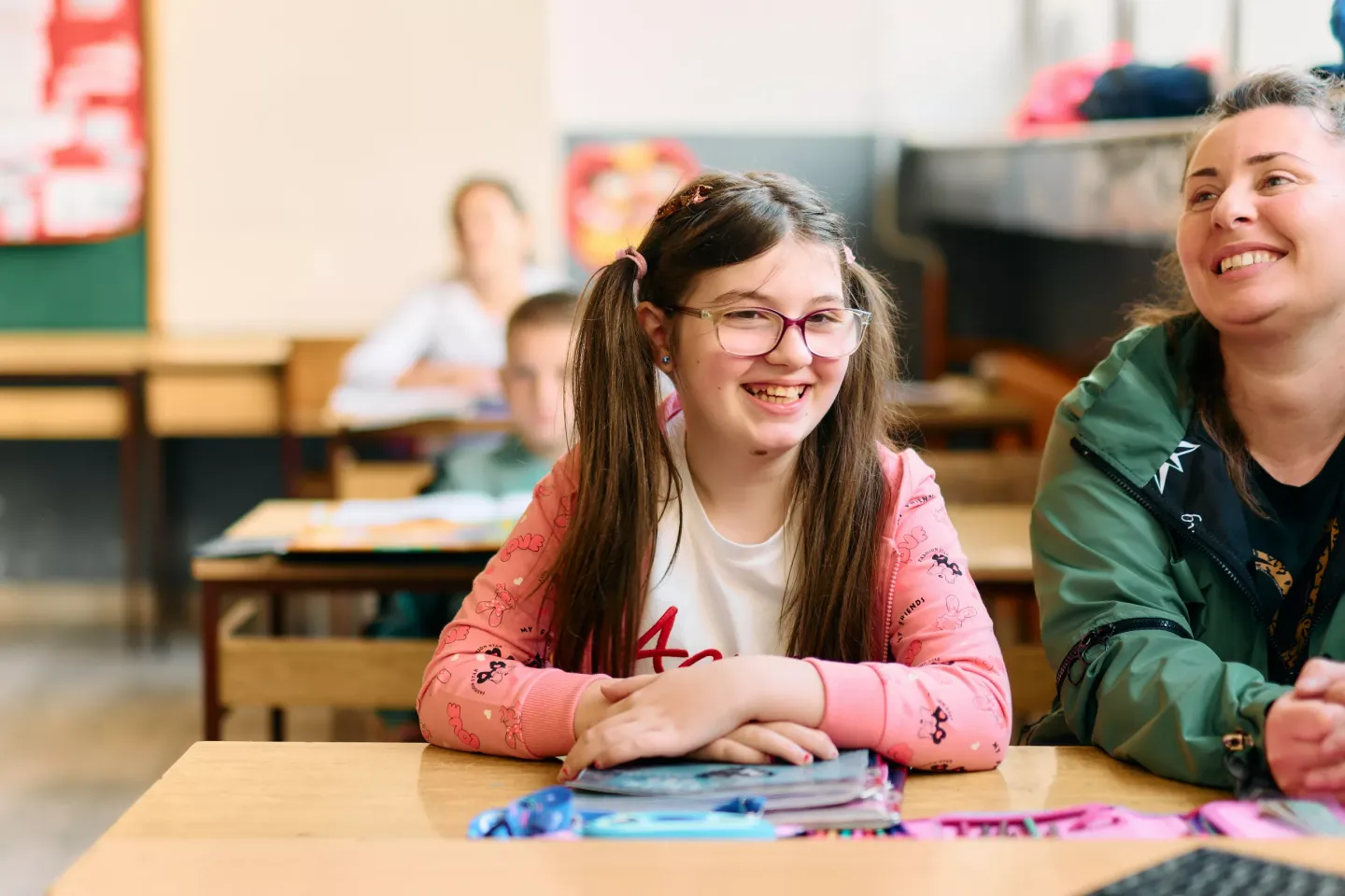 A girl sitting in the classroom and smiling